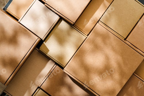 Preview: Stacked cardboard boxes arranged in a neat pattern under natural light