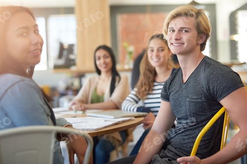 Preview: Portrait of a group of happy students having a study session in a cafe