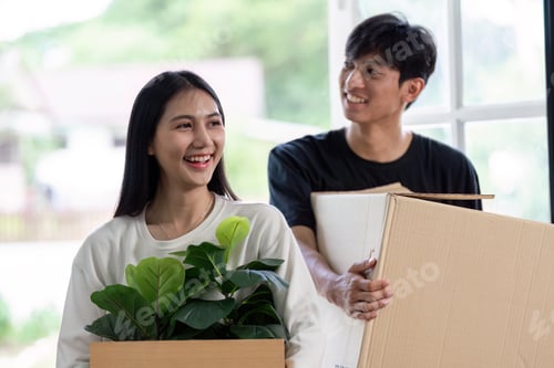 Preview: Happy Couple Moving into New House with Boxes and Plants, Starting a New Chapter in Their Lives