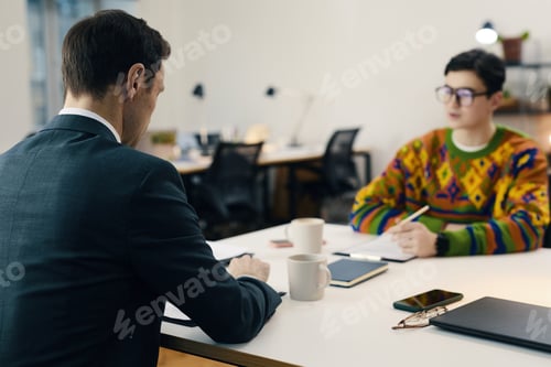 Preview: Businessman Reading CV Of Candidate At Meeting
