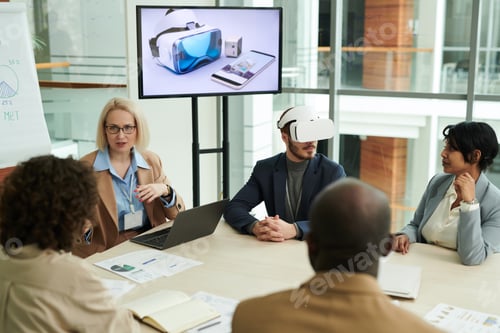 Preview: Group of intercultural colleagues discussing points of presentation
