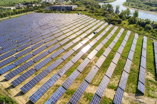 Preview: Aerial view of solar power plant on green field.