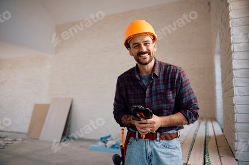 Preview: Happy manual worker during home renovating project looking at camera.