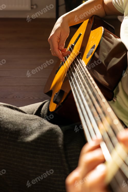 Preview: A woman playing a guitar