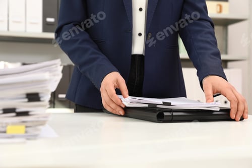 Preview: Woman working with documents at table in office, closeup