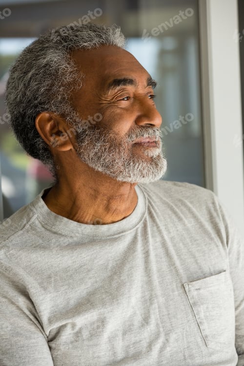Preview: Senior man standing at the entrance of house