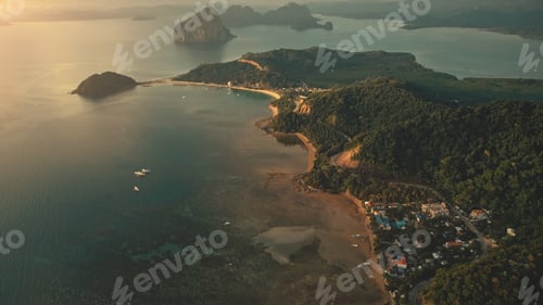 Preview: Sunrise at tropical ocean bay islands aerial view. Mountainous islet with exotic plants, forest