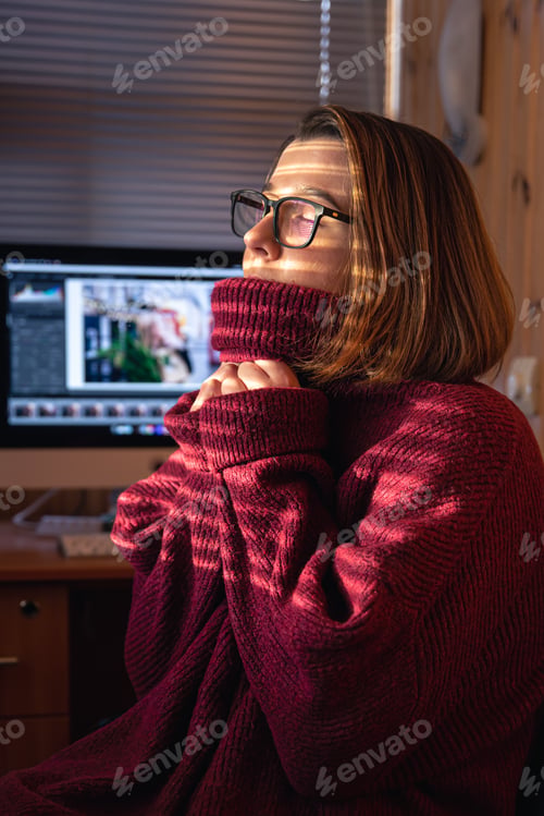 Preview: A woman looks through the blinds at the early morning sunlight.