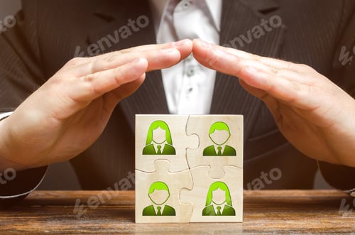 Preview: Businessman covers with hands the business team of employees.