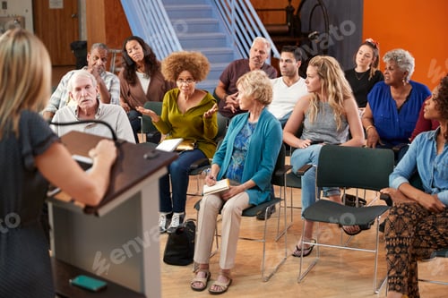 Preview: Group Attending Neighborhood Meeting In Community Center