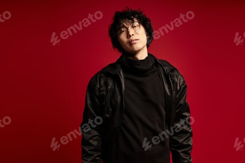 Preview: Crimson reverie a young asian man embraces stylish expression in studio
