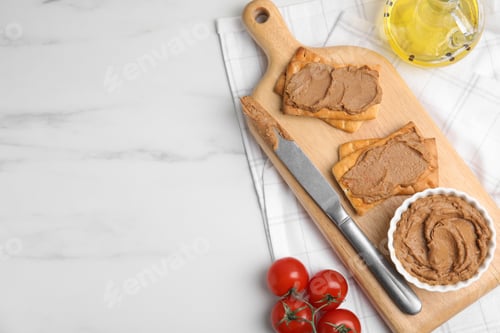 Preview: Crispy crackers with delicious meat pate served on white marble table, flat lay. Space for text