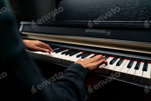 Preview: Close-up of a woman's hands in silver rings playing a beautiful lyrical melody on the piano keys