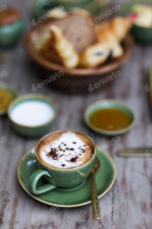 Preview: Cup of aroma cappuccino at breakfast with croissants