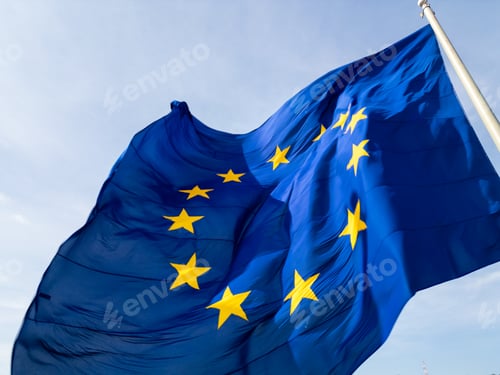 Preview: A close-up shot of the European Union flag waving in the wind, with its iconic blue background and