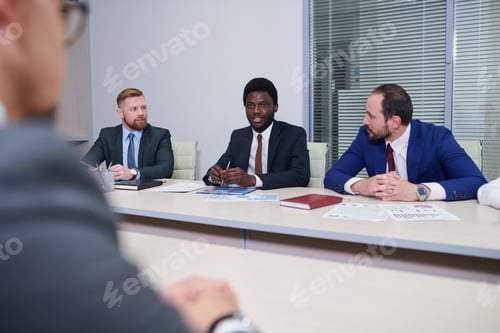 Preview: Group of contemporary traders listening to their African colleague
