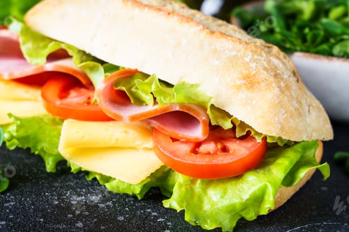 Preview: Ciabatta sandwich with lettuce, cheese, tomatoes and ham.