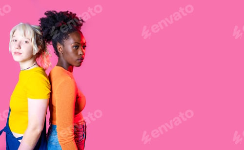 Preview: Two young diverse multicultural caucasian and black women best friends posing isolated background