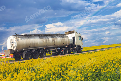 Preview: tank goes on the road. truck rides near the field. rainbow in the blue sky