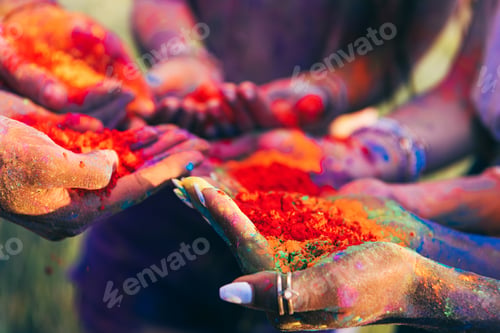 Preview: Close-up Partial View of Young People Holding Colorful Paint in Palms at Holi Festival