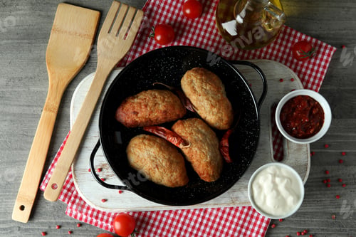 Preview: Concept of tasty food with cutlets on gray textured table
