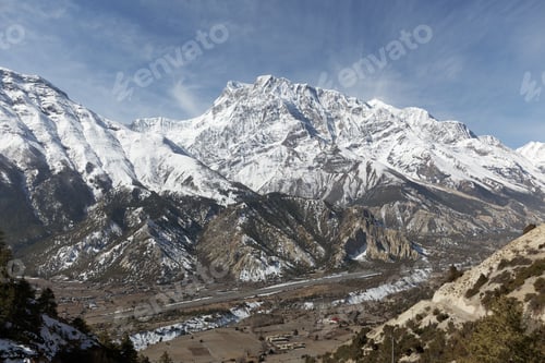 Preview: Majestic snow capped mountains rise above a valley in the himalayas of nepal