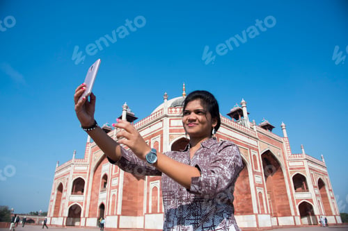 Preview: Young girl taking Photos in front of Humayun's Tomb, Delhi, India.