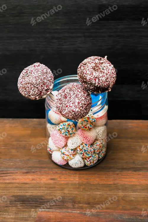 Preview: Delicious sweet chocolate cake pops,popsicles white sprinkles,pastry,desserts on stick. Tasty food