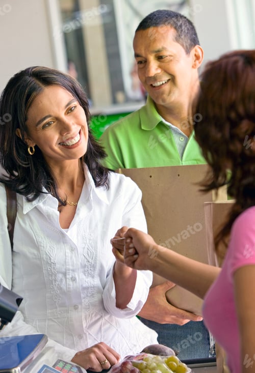 Preview: Beautiful Couple Smiling - A Supermarket Checkout With Shopping Till In A Market
