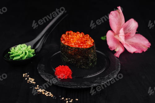 Preview: Gunkan maki sushi with red caviar and wasabi on black background