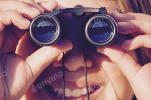 Preview: Binoculars used by a Young Adult Close Up