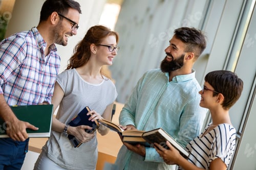 Preview: Happy group of success students studying and working together in a college library