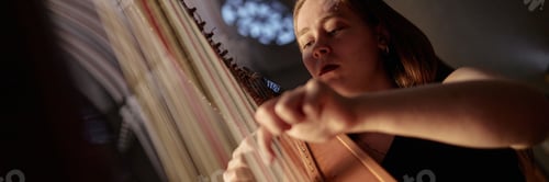 Preview: Header Image of Female Harpist Playing Harp Music in Church