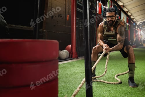 Preview: Sled drag exercise. Sportsman during his cross training workout.