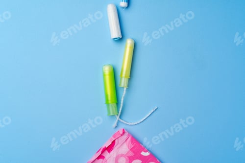 Preview: Female hygienic pad and tampons on blue background