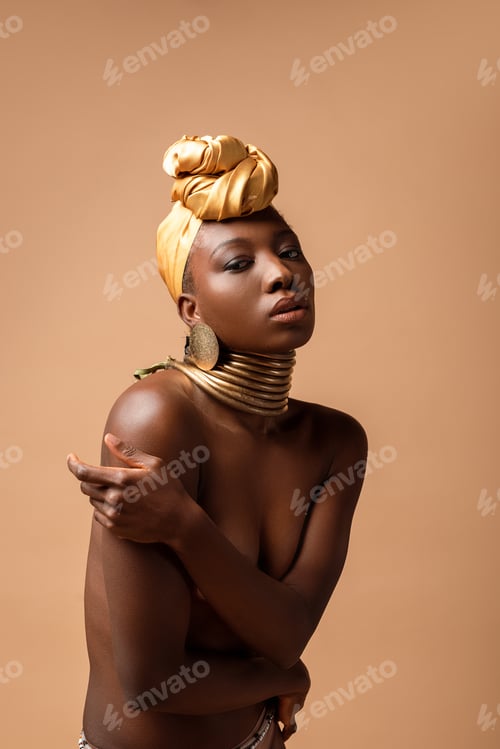 Preview: sexy naked tribal afro woman posing isolated on beige