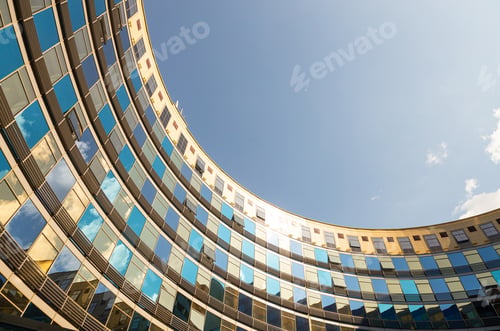 Preview: Bottom view of semicircle bulding with glass walls of blue and golden colors