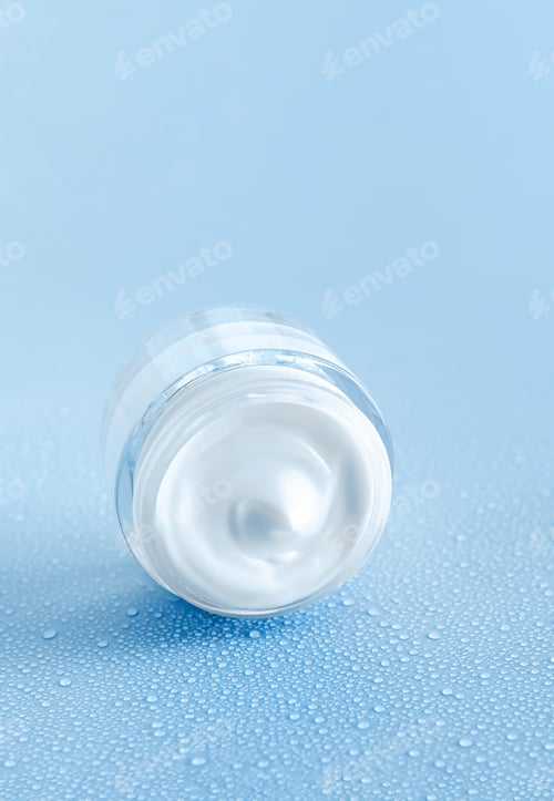 Preview: cream jar on blue background with water drops