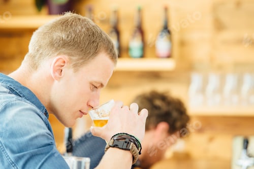 Preview: Handsome man smeeling beer