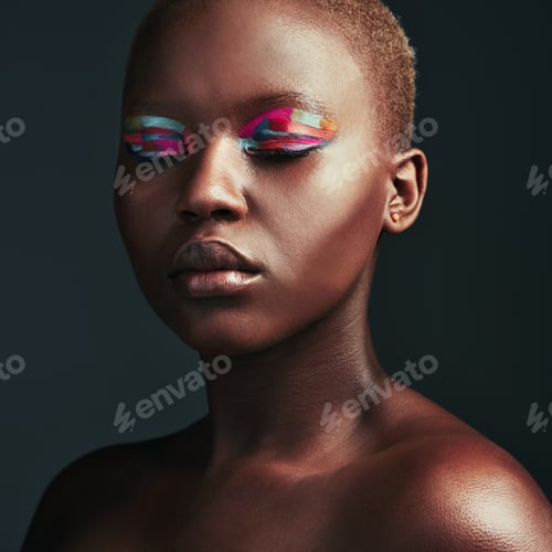 Preview: Cropped shot of a beautiful woman wearing colorful eyeshadow while posing against a grey background