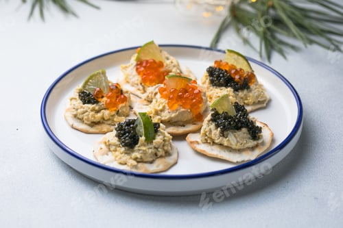 Preview: Holiday canapes with red and black caviar, on crackers festive silver Christmas decoration