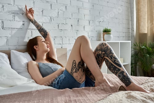 Preview: Tattooed woman relaxing on a cozy weekend