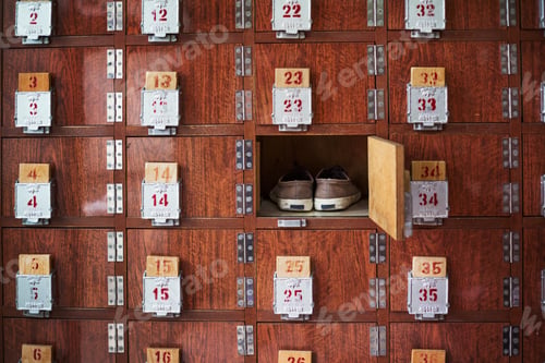 Preview: A row of shoe lockers with one open door, and one pair of shoes stored.