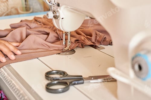 Preview: Closeup shot of a sewing process in the phase of overstitching