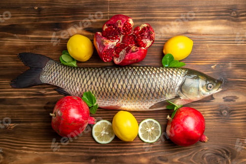 Preview: top view fresh fish with pomegranates and lemon on a wooden desk ocean food sea seafood
