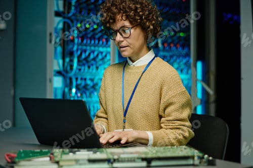 Preview: Engineer woman working with laptop in data center
