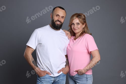 Preview: Portrait of lovely couple on grey background