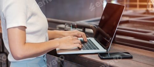 Preview: woman using smartphone and laptop, freelance woman typing keyboard computer notebook in cafe