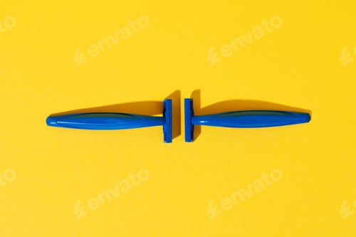 Preview: Disposable razors on yellow background, studio shot
