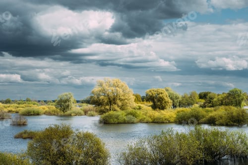 Preview: Countryside Landscape During Spring Flood Floodwaters. Bold Bright Blue Sky Above Nature Landscape